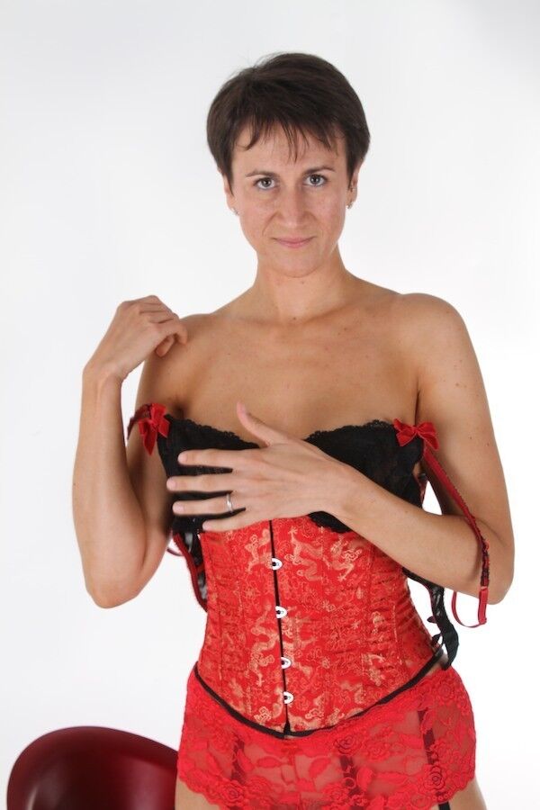 Housewife Michaela wearing a red corset