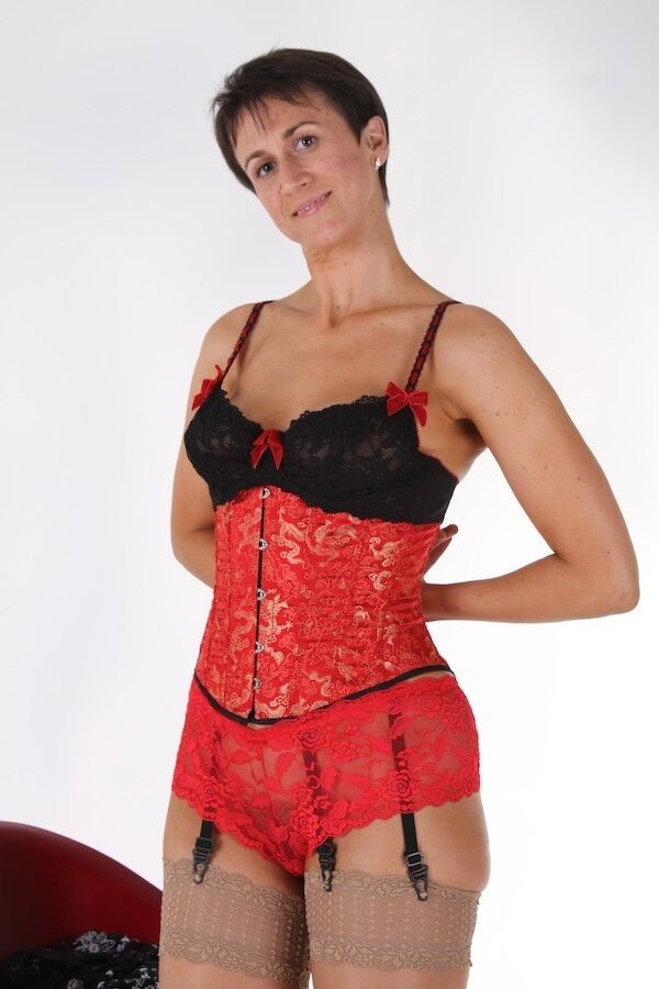 Housewife Michaela wearing a red corset