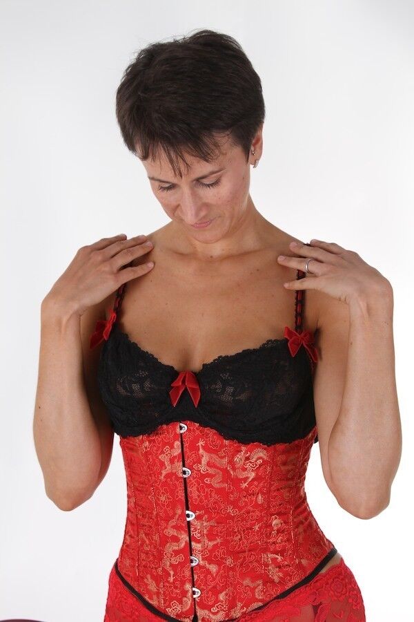 Housewife Michaela wearing a red corset