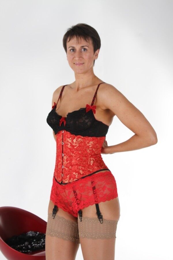 Housewife Michaela wearing a red corset